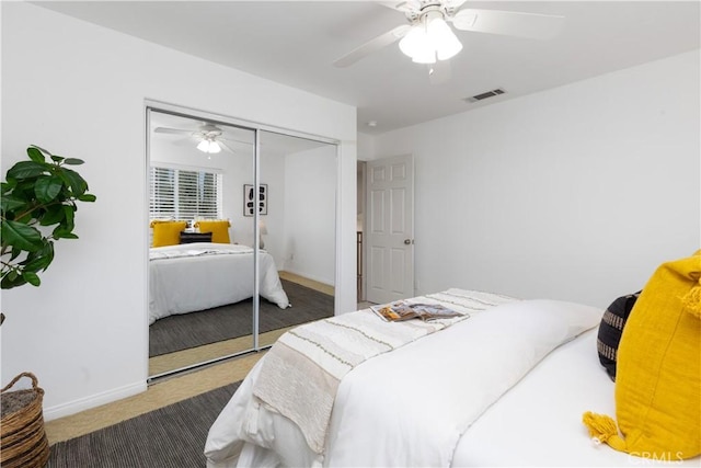 bedroom with ceiling fan, visible vents, baseboards, a closet, and carpet