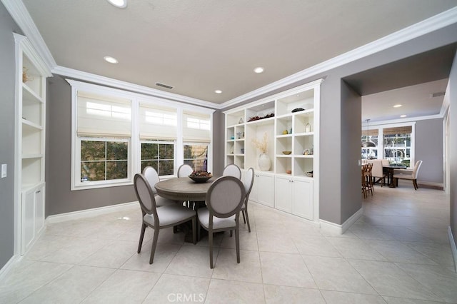 dining room with built in shelves, visible vents, and crown molding