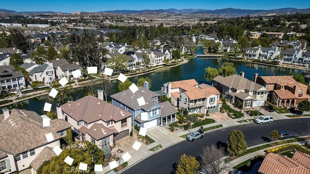 birds eye view of property featuring a water view and a residential view