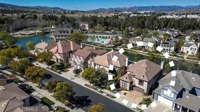 birds eye view of property featuring a water and mountain view and a residential view