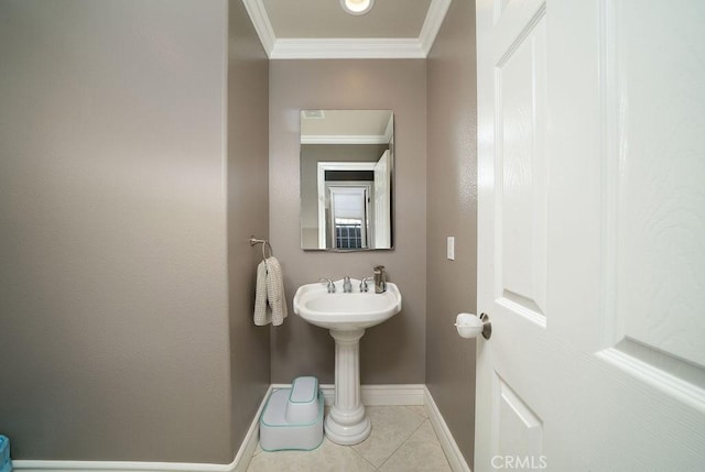 bathroom featuring tile patterned flooring, ornamental molding, and baseboards