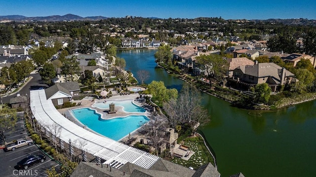 birds eye view of property with a water view and a residential view