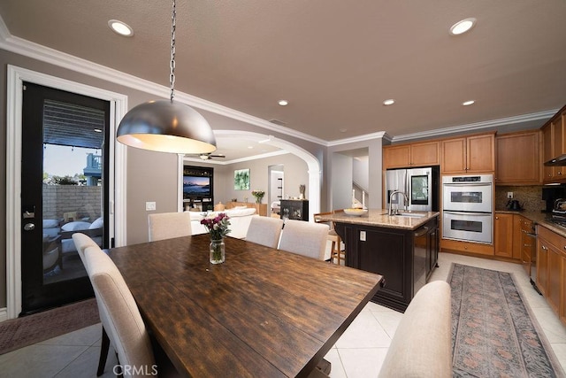 dining room featuring arched walkways, recessed lighting, visible vents, ornamental molding, and light tile patterned flooring