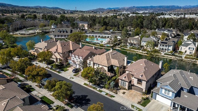 birds eye view of property featuring a residential view and a water and mountain view