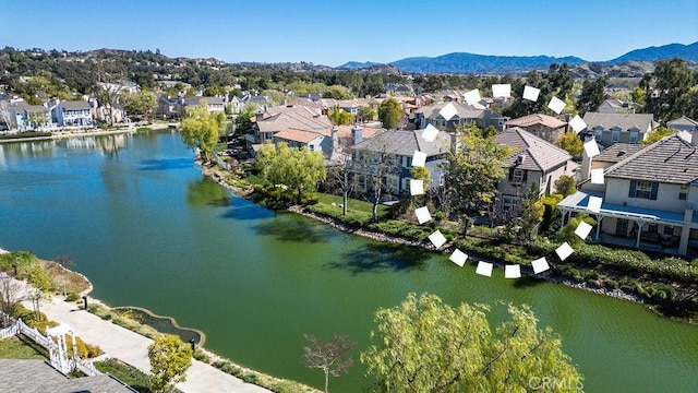 aerial view with a water and mountain view and a residential view