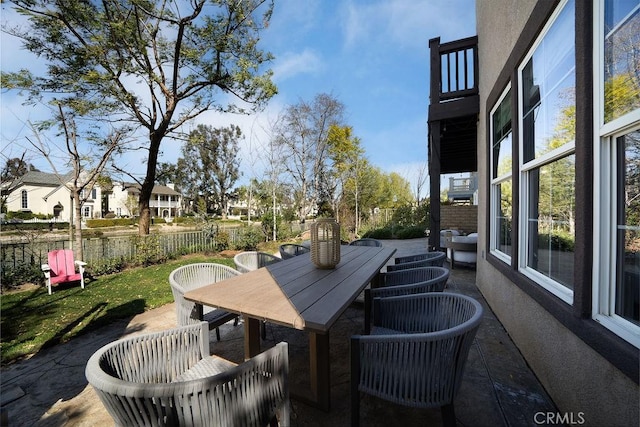 view of patio with fence and outdoor dining space