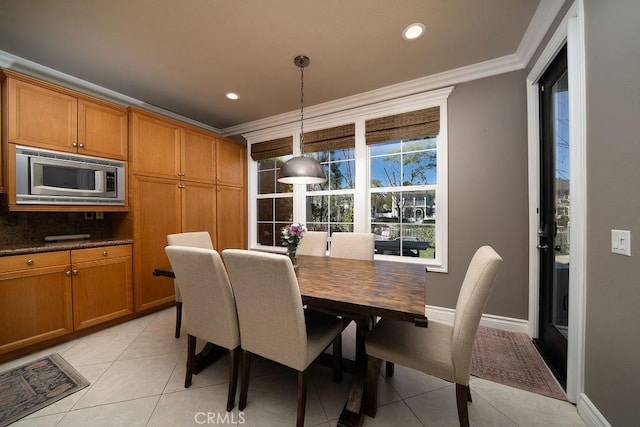 dining space featuring light tile patterned floors, baseboards, ornamental molding, and recessed lighting