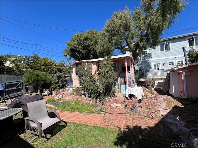 view of yard with fence and an outbuilding