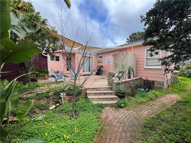 back of property featuring a patio