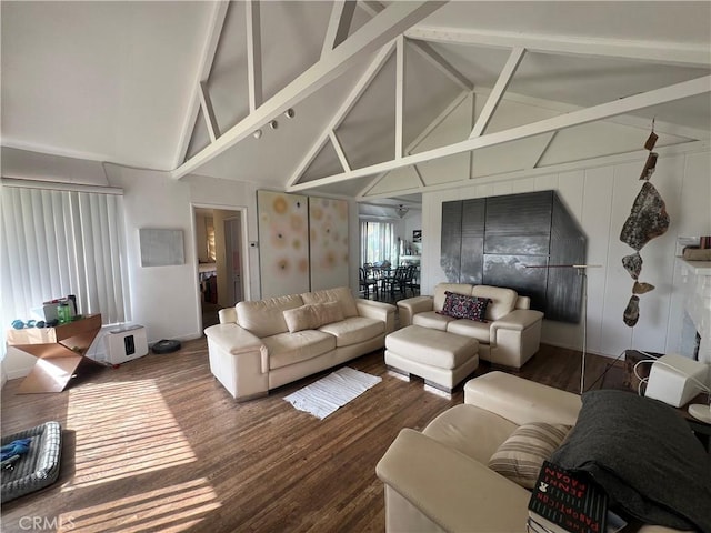 living area with high vaulted ceiling, beamed ceiling, and wood finished floors