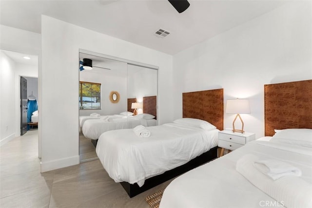 bedroom with baseboards, visible vents, ceiling fan, and a closet