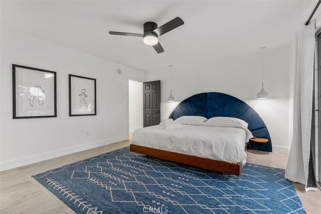 bedroom featuring ceiling fan and baseboards