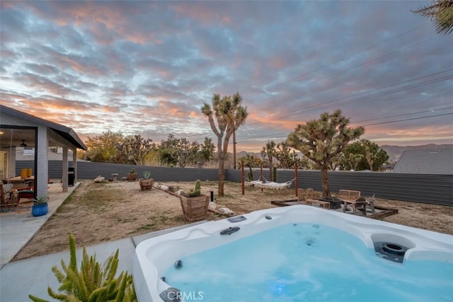 view of yard with a fenced backyard and a hot tub