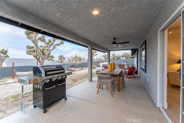 view of patio with ceiling fan, grilling area, fence, and outdoor dining area