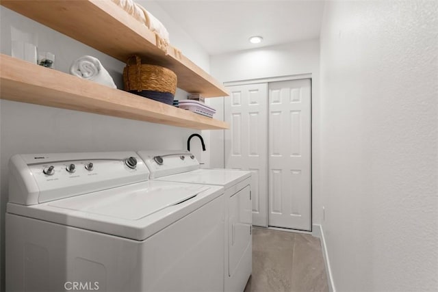 laundry room featuring laundry area, separate washer and dryer, and baseboards