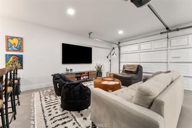 living room featuring a garage, recessed lighting, finished concrete flooring, and baseboards