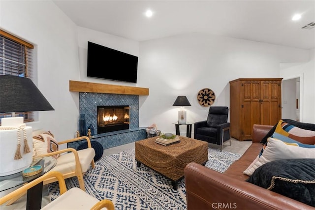 carpeted living area with a premium fireplace, visible vents, and recessed lighting