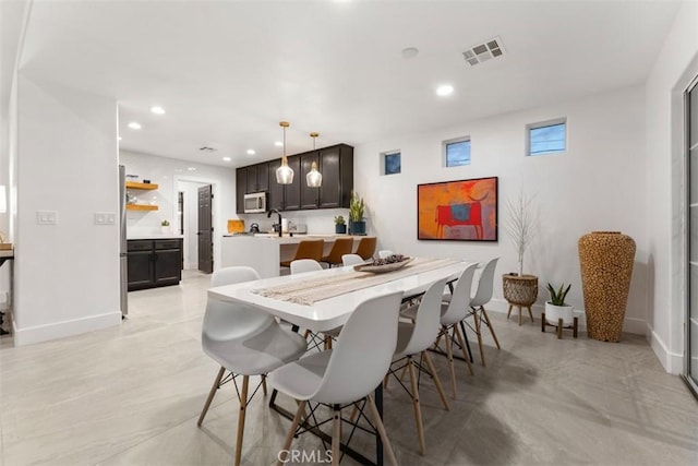 dining area with baseboards, visible vents, and recessed lighting