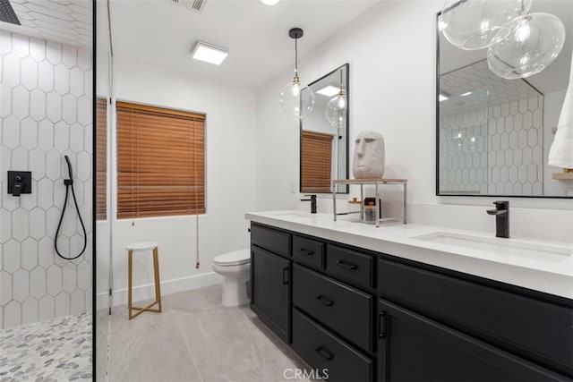 full bathroom featuring double vanity, a sink, toilet, and walk in shower