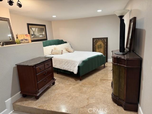 bedroom featuring baseboards and recessed lighting