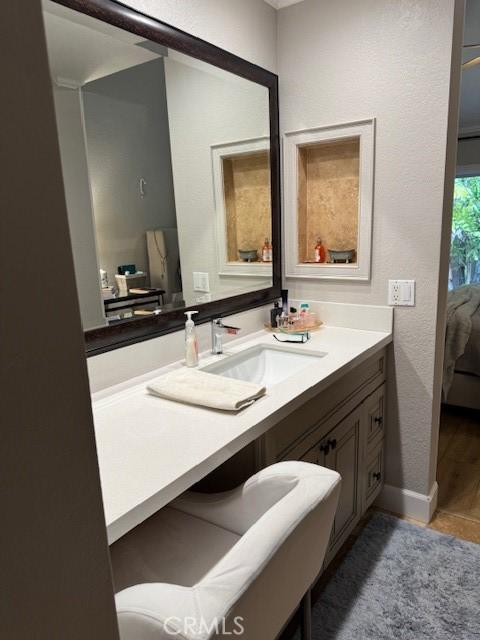 ensuite bathroom featuring ensuite bath and vanity