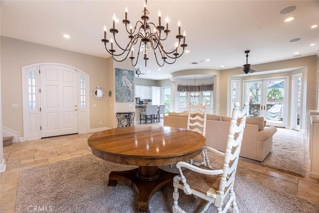 dining room featuring an inviting chandelier, baseboards, stone tile flooring, and recessed lighting