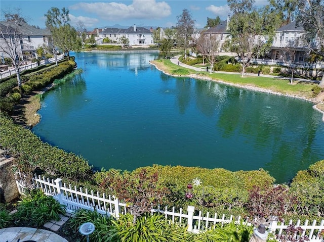 view of water feature featuring fence and a residential view