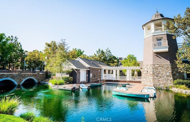 view of pool with a water view and a pergola