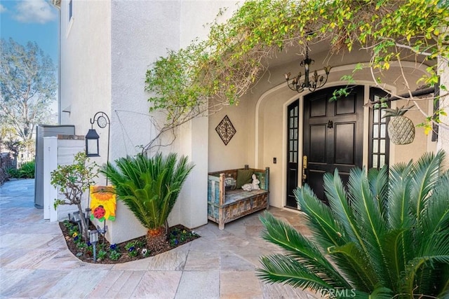 property entrance with stucco siding