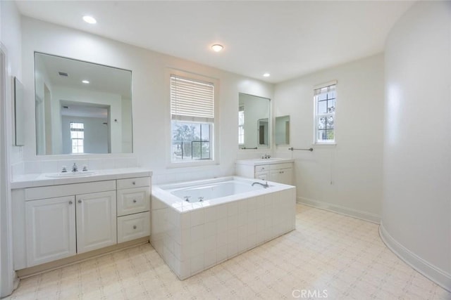 full bath featuring recessed lighting, tile patterned floors, a sink, baseboards, and a bath