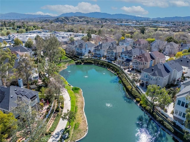 drone / aerial view with a residential view and a water and mountain view