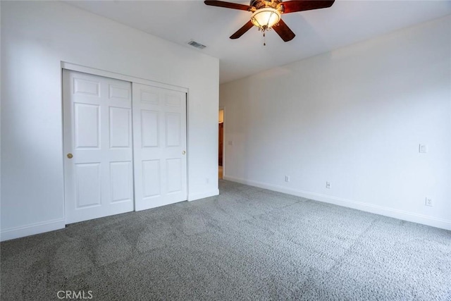 unfurnished bedroom with baseboards, a closet, visible vents, and carpet flooring