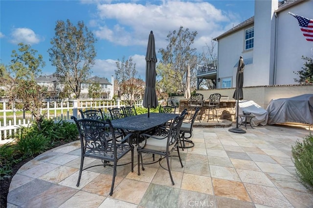 view of patio / terrace featuring outdoor dining area and fence