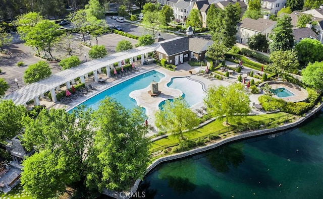 birds eye view of property with a water view and a residential view