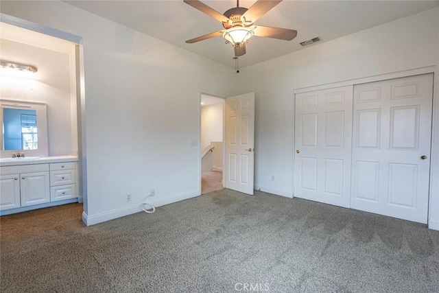 unfurnished bedroom featuring a closet, carpet, visible vents, and baseboards