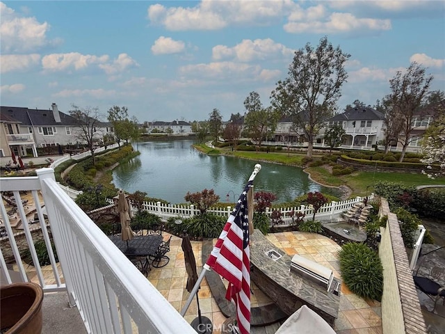 property view of water with a residential view and fence