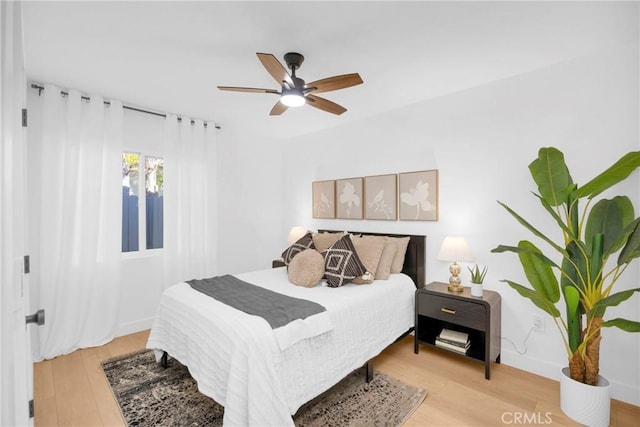 bedroom with light wood-style floors and a ceiling fan