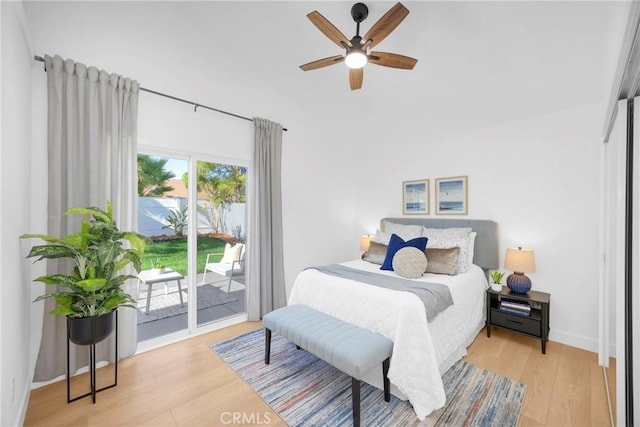 bedroom featuring baseboards, access to outside, a ceiling fan, and wood finished floors