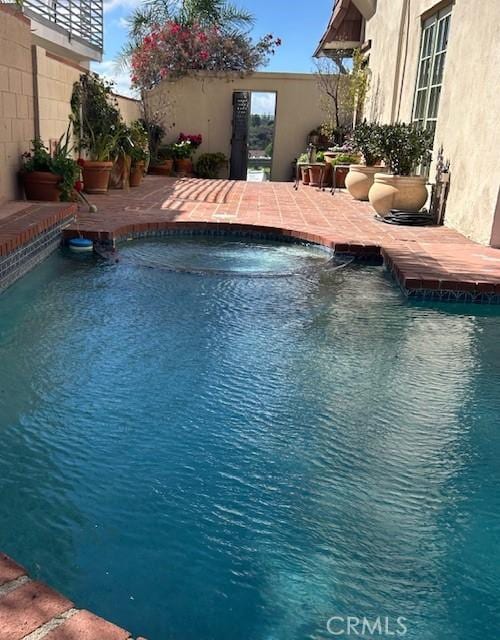 view of swimming pool with a fenced in pool and a patio area
