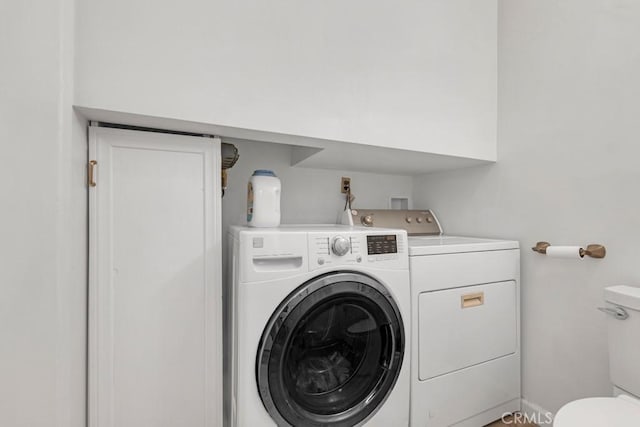 laundry room featuring separate washer and dryer and laundry area