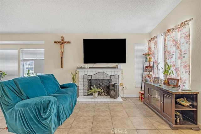 living area with light tile patterned floors, a textured ceiling, a fireplace, baseboards, and vaulted ceiling