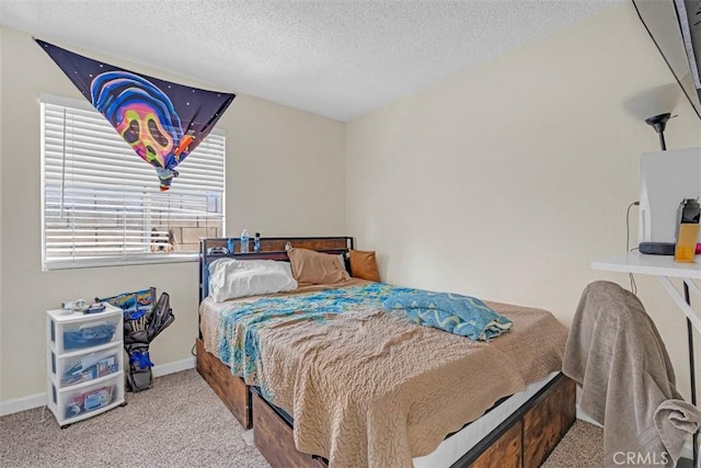 bedroom featuring carpet flooring, a textured ceiling, and baseboards