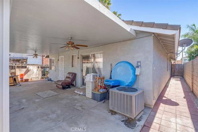 view of patio featuring a ceiling fan, cooling unit, and fence