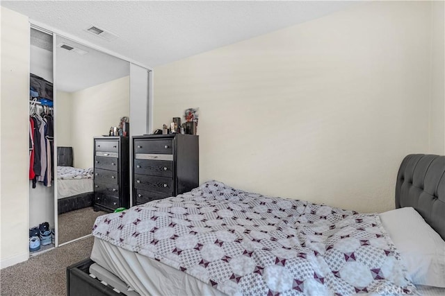 bedroom with carpet floors, baseboards, and visible vents