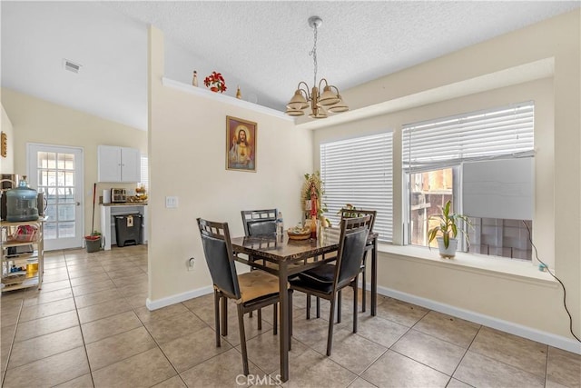 dining space featuring a notable chandelier, visible vents, light tile patterned flooring, vaulted ceiling, and a textured ceiling