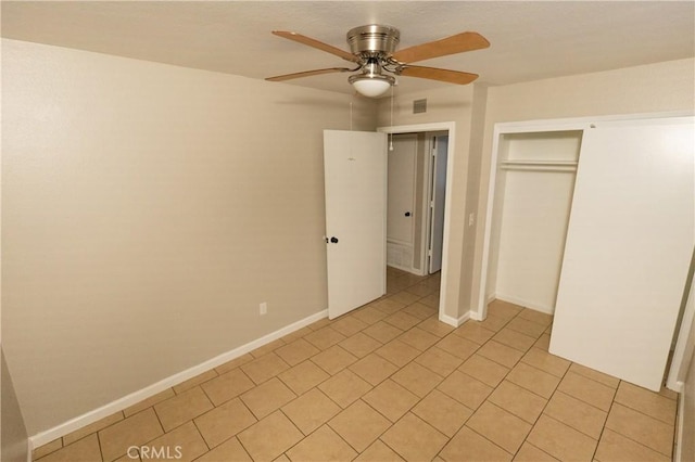 unfurnished bedroom featuring visible vents, baseboards, ceiling fan, a closet, and light tile patterned flooring