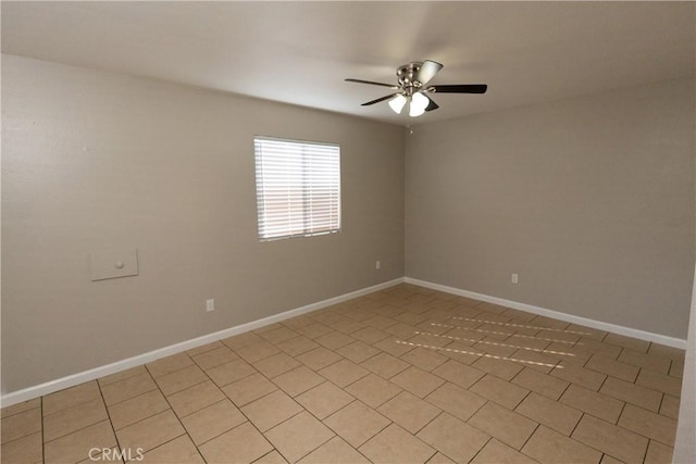 unfurnished room with ceiling fan and baseboards