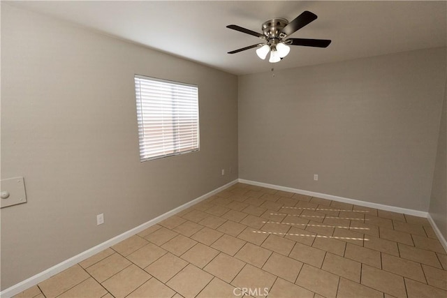 empty room featuring baseboards and a ceiling fan