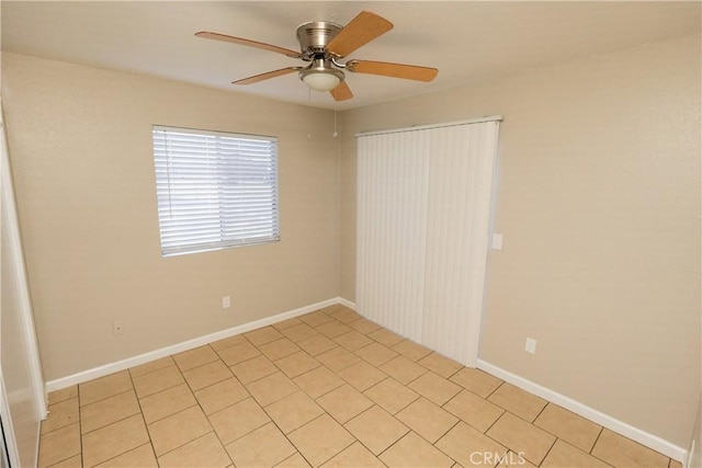 unfurnished room with ceiling fan and baseboards