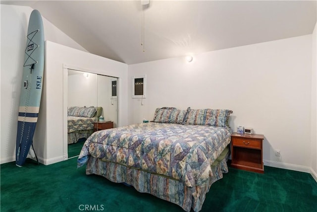 bedroom featuring carpet floors, a closet, vaulted ceiling, and baseboards